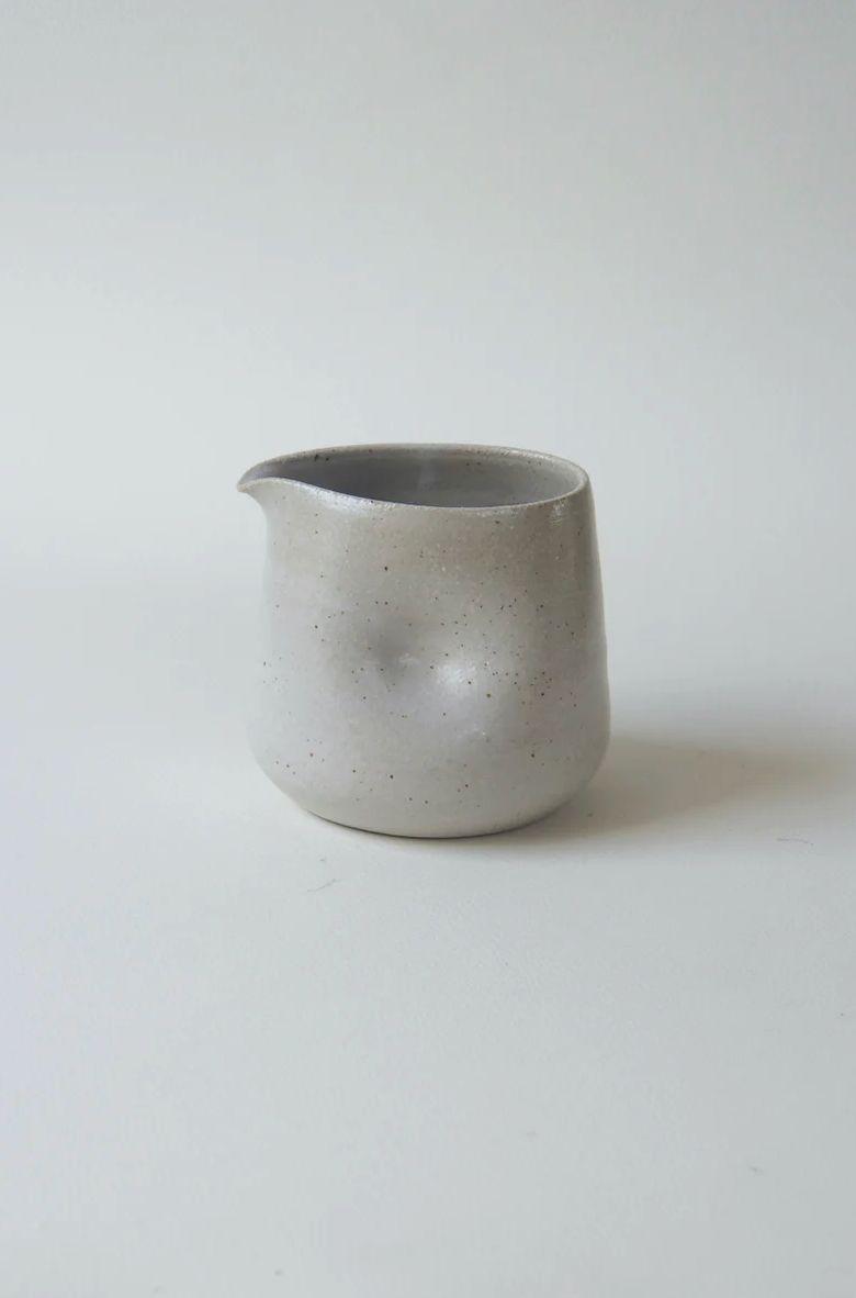 Handmade stoneware gravy pourer with dimpled grip by Kura Studio, Australian ceramics